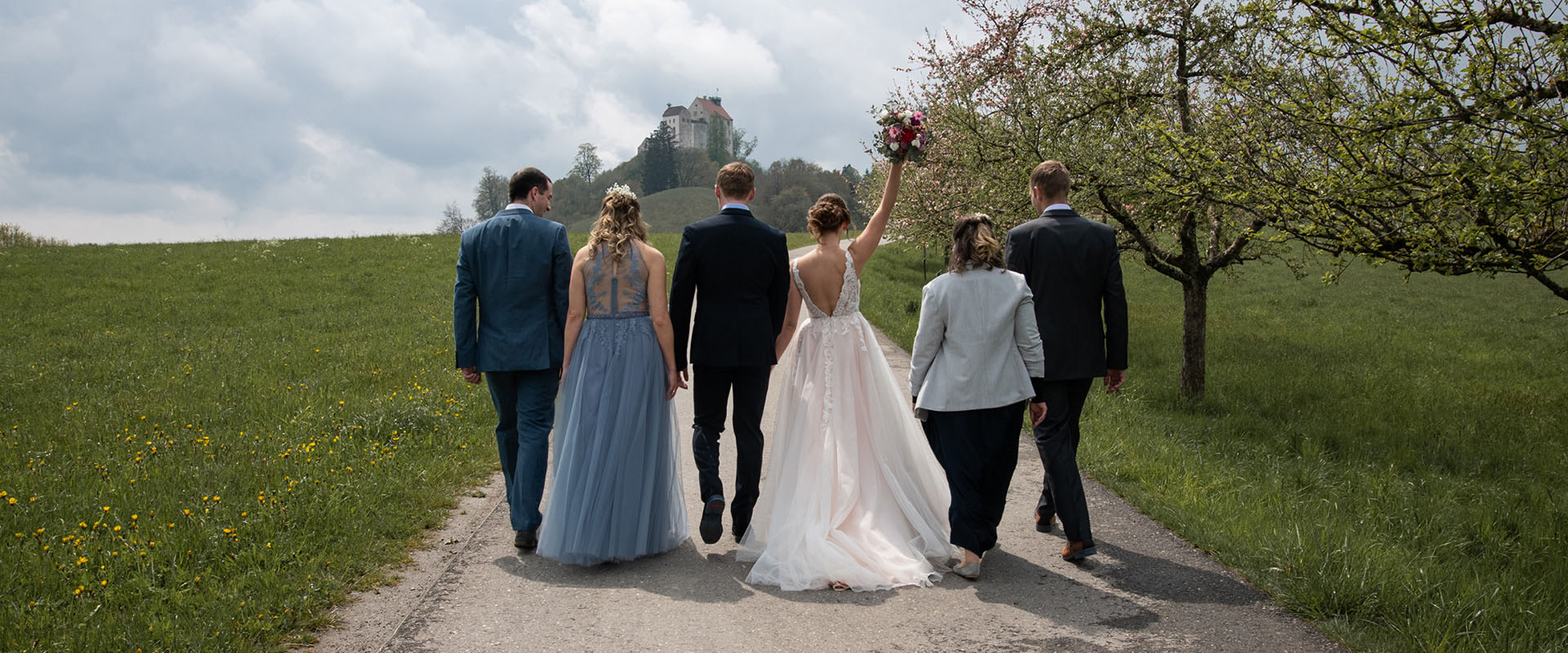 Hochzeit Brautpaar und Trauzeugen laufen zur Waldburg